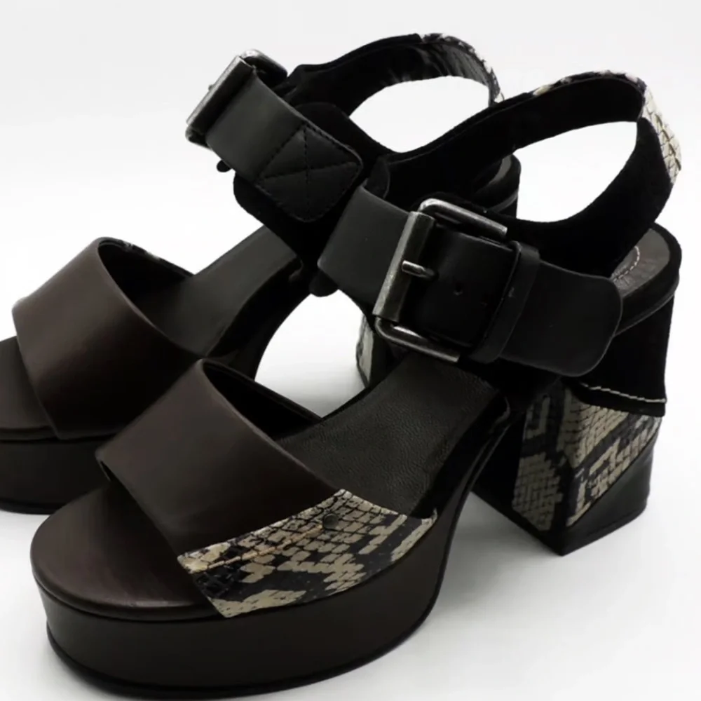 See by Chloe . Black , brown and python print platform heels.